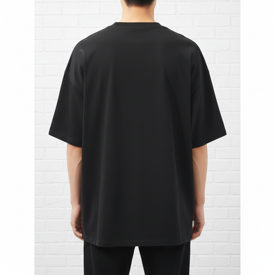 Back view of male model wearing black drop shoulder t-shirt