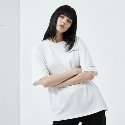 Female model leaning with arms crossed wearing MORTENOIR t-shirt