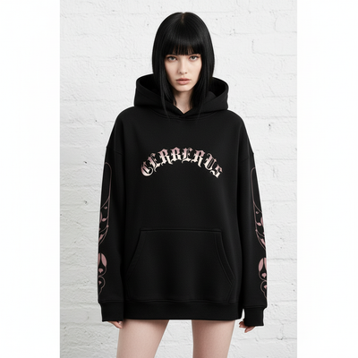 Front view of female model with black hair and bangs wearing black oversized hoodie