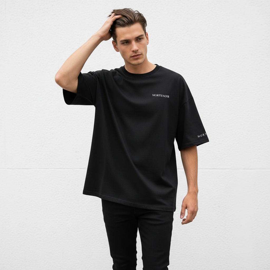 Male model in candid walking pose wearing black t-shirt
