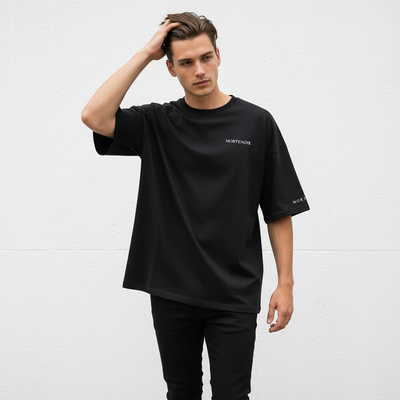 Male model in candid walking pose wearing black t-shirt